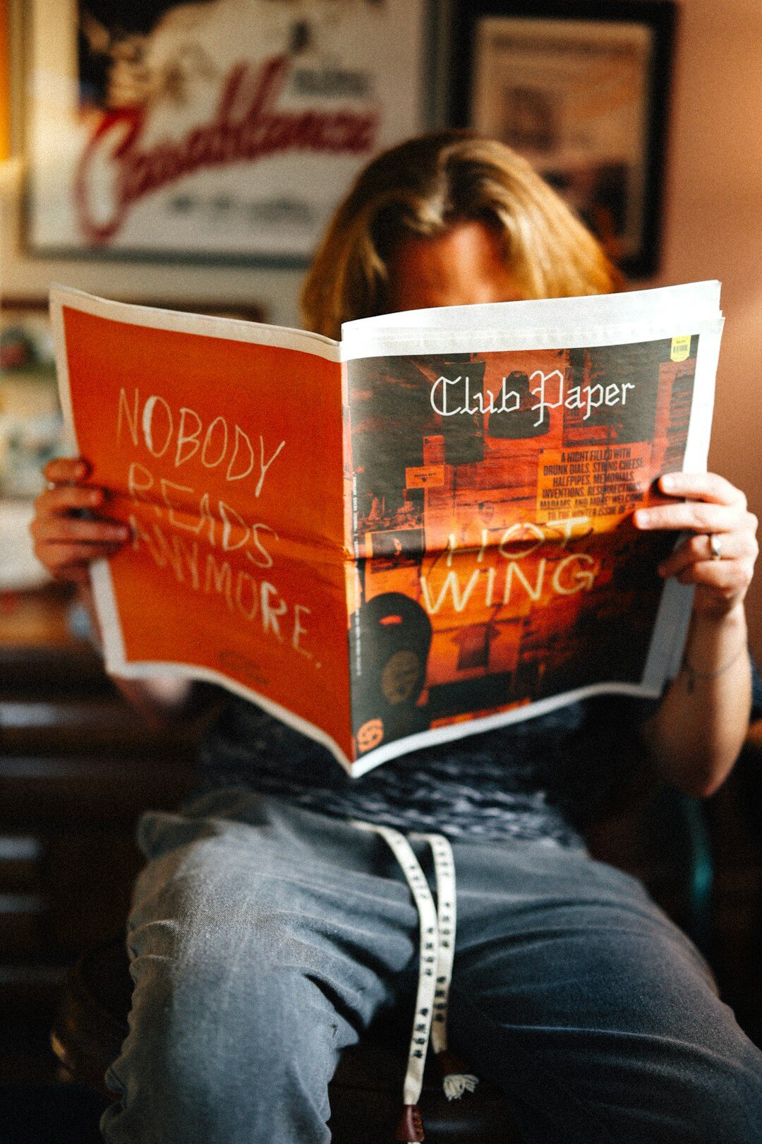 person reading newspaper at home
